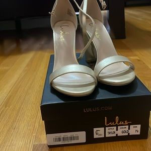 Gold women’s strapped high heel